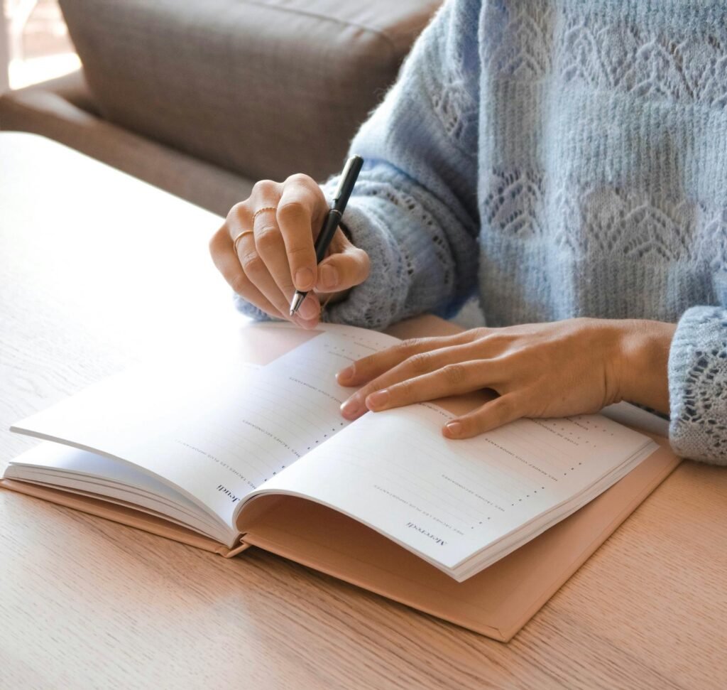 Woman writing her daily tasks in a planner