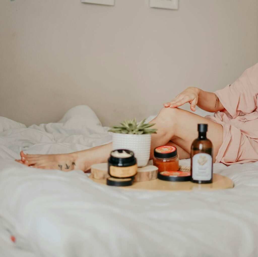 Woman gently applying body scrub to her legs
