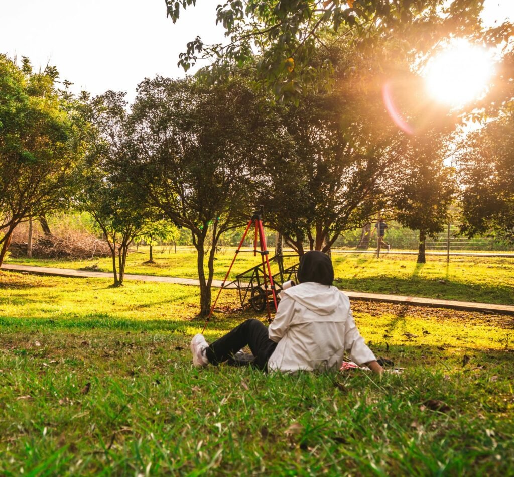 Person sitting on the grass and enjoying time outdoors