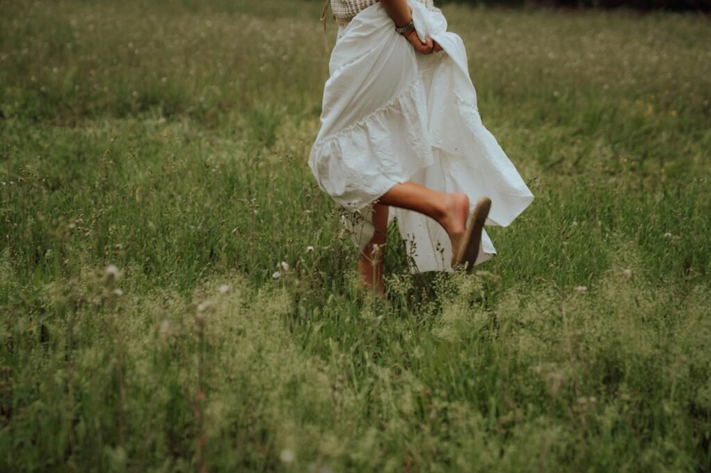 Woman walking on grass wearing sandals
